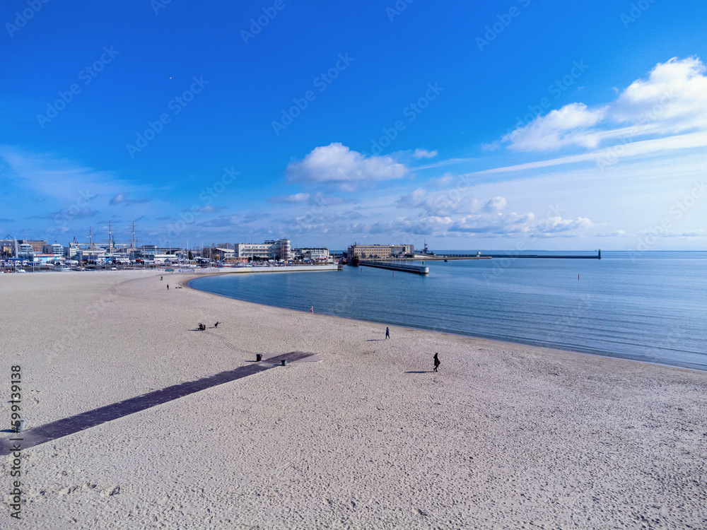 Aerial view landscape. Urban beach in Poland, Gdynia. Photo from a drone. View of the harbor and marine. Baltic Sea.