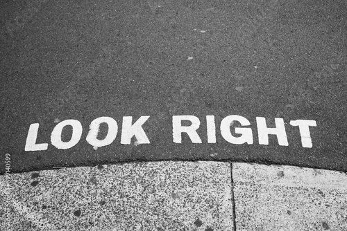 Look right sign painted on road advising care when stepping of path