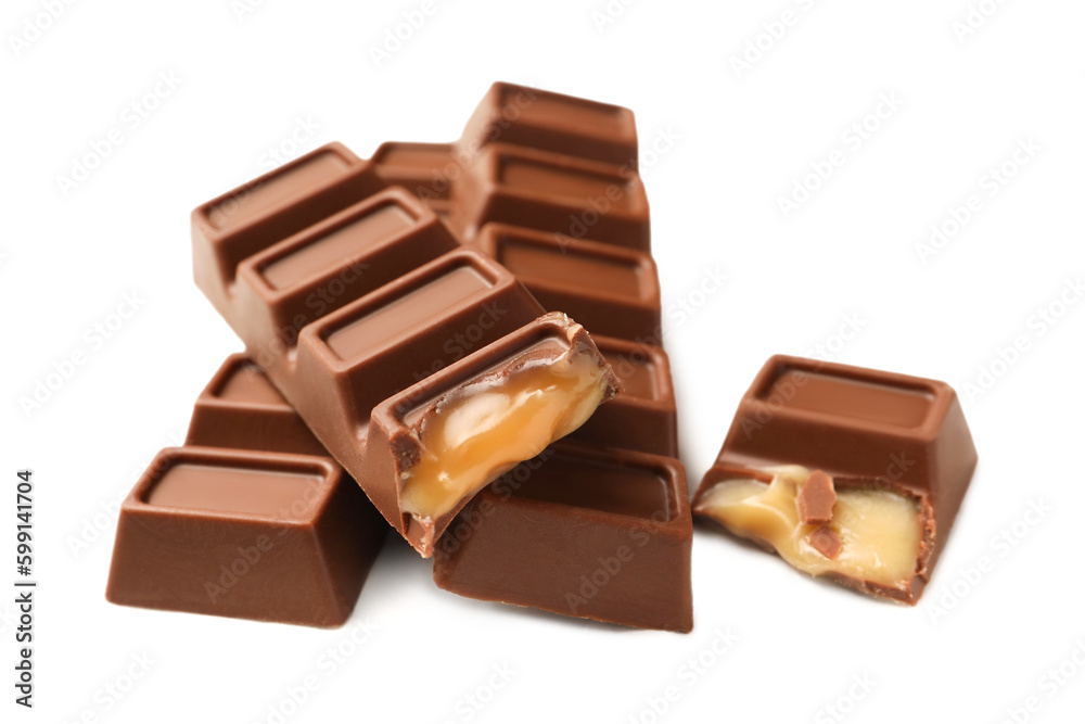 Tasty sweet chocolate bars on white table, closeup Tasty sweet chocolate bars on white table, closeup