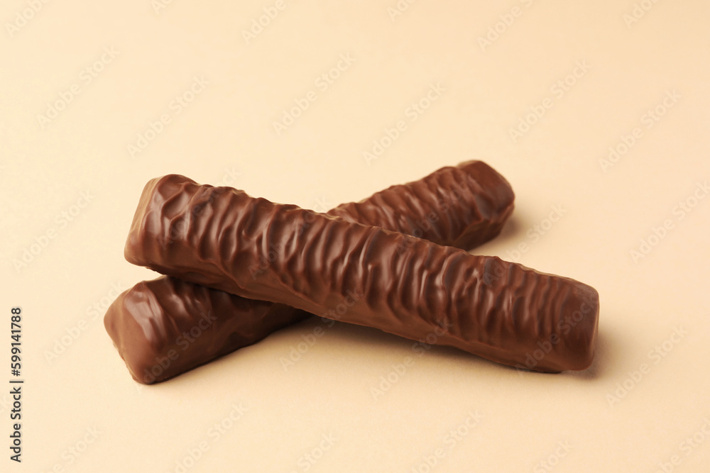 Sweet tasty chocolate bars on beige background Sweet tasty chocolate bars on beige background