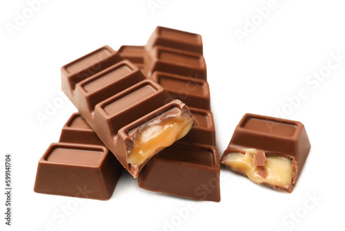 Tasty sweet chocolate bars on white table, closeup