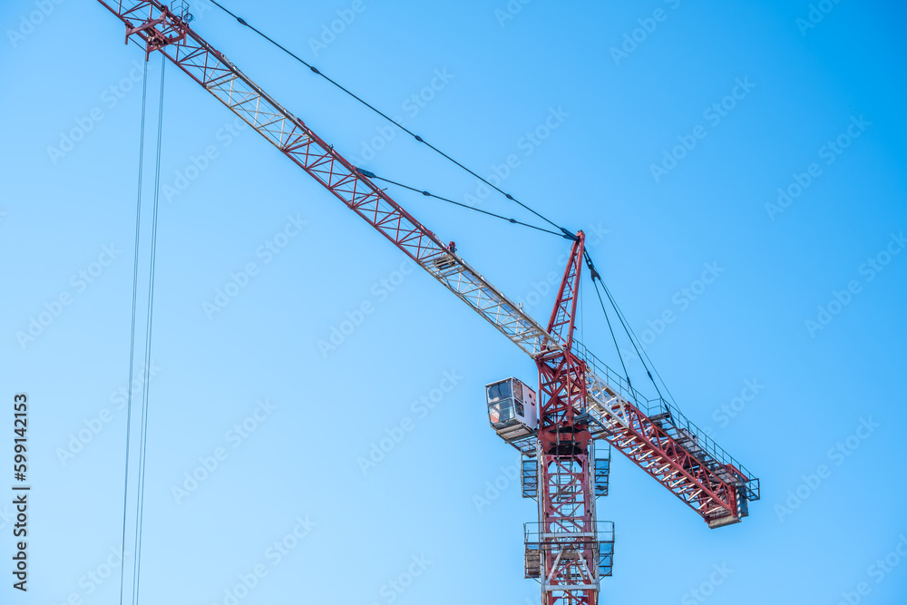 A tall tower crane against the sky.