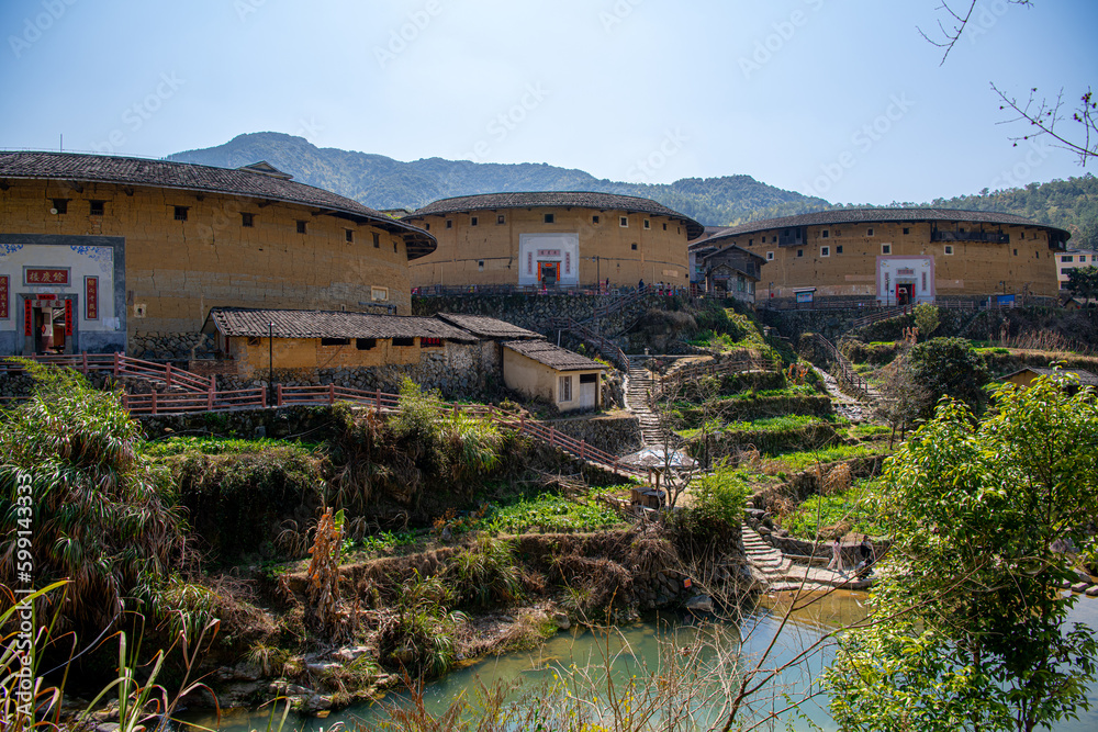 Yongding, Longyan, Fujian province, China - Mar 1st, 2021: The Fujian earthern buildings (also known as Hakka tulou) in mountains. These buildings are in Chuxi village.