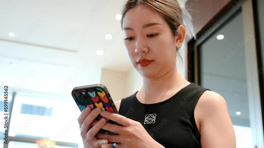 Taking a moment to unwind, a tourist woman sits comfortably on a coach and types on her phone. With technology at her fingertips, she can stay connected even during moments of leisure and relaxation. Taking a moment to unwind, a tourist woman sits comfortably on a coach and types on her phone. With technology at her fingertips, she can stay connected even during moments of leisure and relaxation.