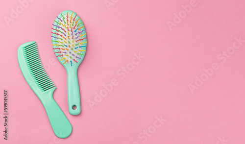 Hair comb and brush on a pink background. Copy space for text
