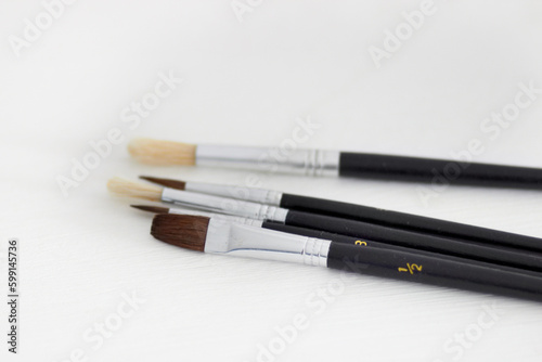 Paint brush, creativity and table background with hobby and diy tool. Creative, painter and artist tools for house renovation, canvas or artistic work with equipment for painting and decorating