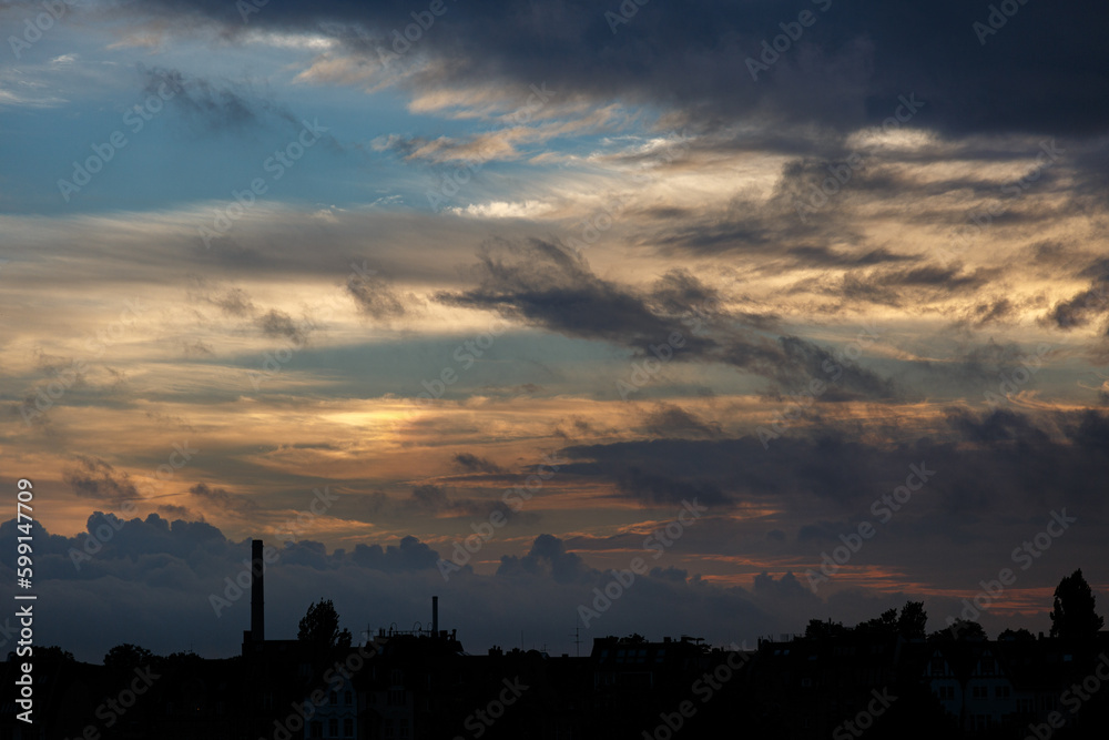 Dramatic sky with clouds on sunset over the city Dramatic sky with clouds on sunset over the city