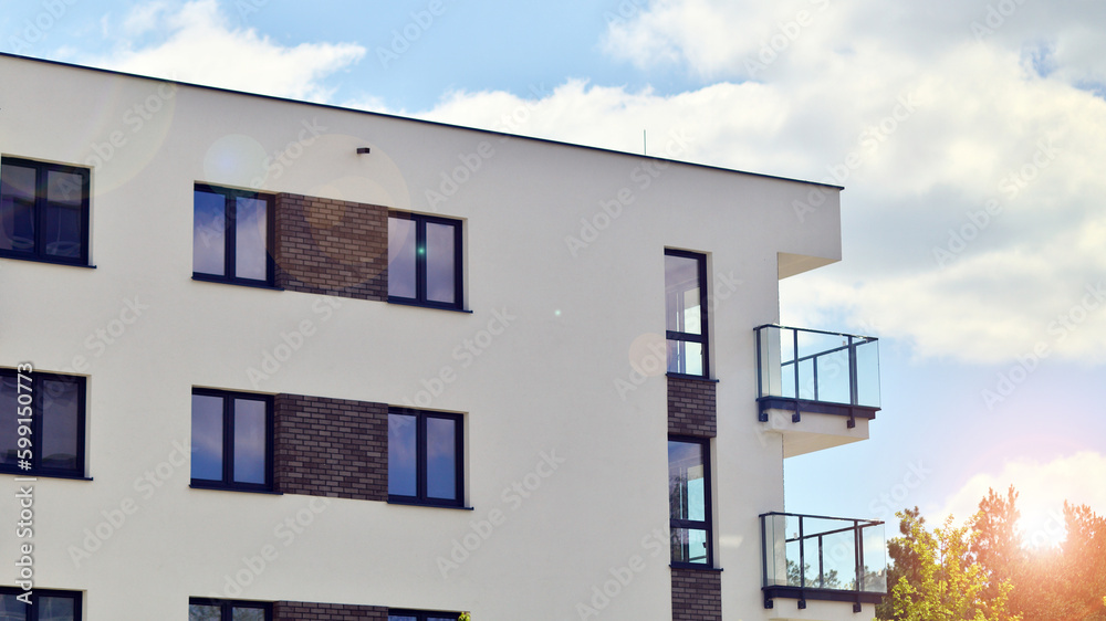 Modern apartment buildings on a sunny day with a blue sky. Facade of a modern apartment building. Contemporary residential building exterior in the daylight. Modern apartment buildings on a sunny day with a blue sky. Facade of a modern apartment building. Contemporary residential building exterior in the daylight.