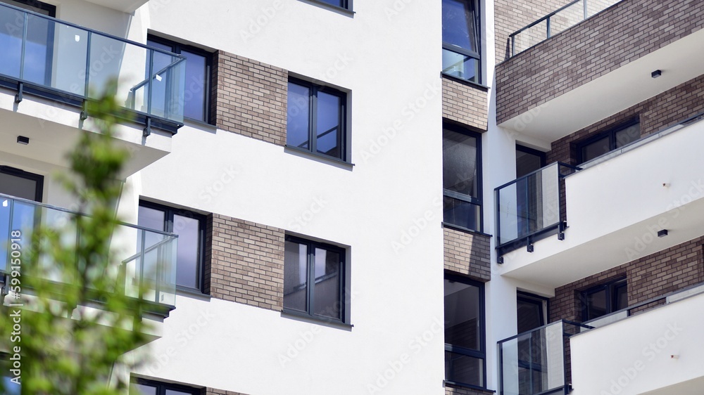 Modern apartment buildings on a sunny day with a blue sky. Facade of a modern apartment building. Contemporary residential building exterior in the daylight. Modern apartment buildings on a sunny day with a blue sky. Facade of a modern apartment building. Contemporary residential building exterior in the daylight.