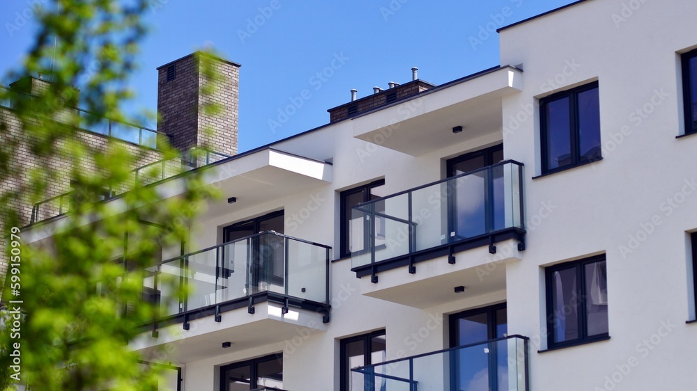 Modern apartment buildings on a sunny day with a blue sky. Facade of a modern apartment building. Contemporary residential building exterior in the daylight. 