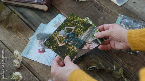 Woman looking at printed photos for family photo album. photo