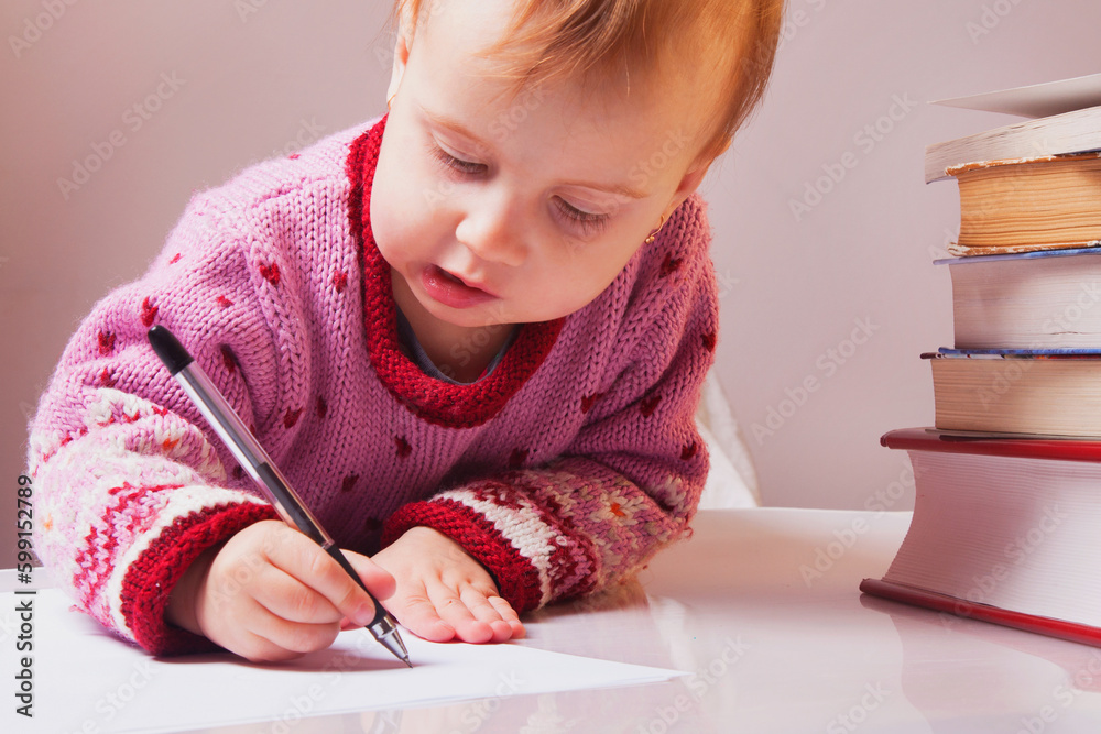 Little beautiful baby girl writing in her book (Education, knowledge, work, success concept) Little beautiful baby girl writing in her book (Education, knowledge, work, success concept)