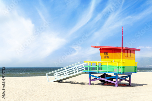A vibrant photo of a lifeguard tower in the colors of the pride flag © karandaev