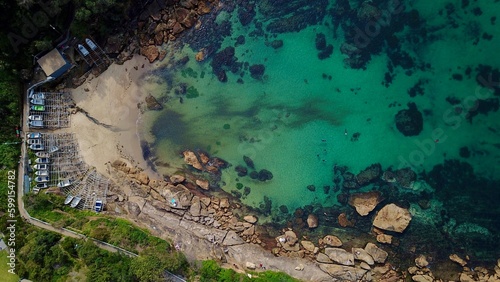 Aerial of a hidden NSW beach with boat on wood boat ramp photo