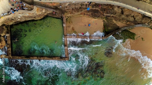 Aerial view of a Ocean Pool with waves clashing on it