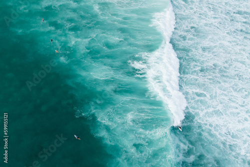 Drone shot of Surfer riding a wave in Oahu, Hawaii