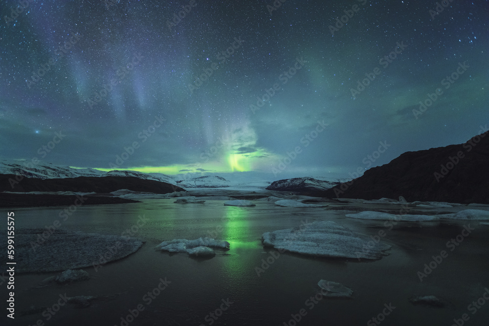 Scenic view of aurora borealis over icebergs in Iceland