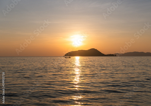 Lonely fisherman with his boat at sunset