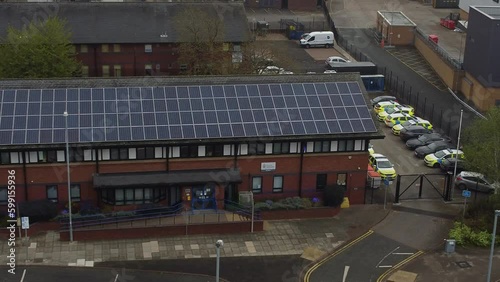 Wallpaper Mural Widnes town police station with solar panel renewable energy rooftop in Cheshire townscape orbit left aerial view Torontodigital.ca
