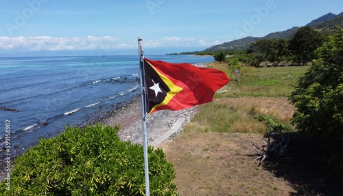 National flag of Timor-Leste gently flapping in the wind on the tropical Atauro Island, flag photo