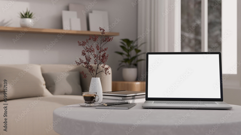 A laptop mockup on a coffee table in modern cozy living room. close-up workspace. A laptop mockup on a coffee table in modern cozy living room. close-up workspace.