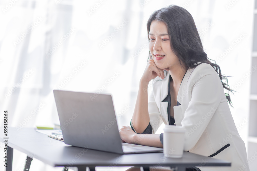 Financial Business asian women analyze the graph of the company's performance to create profits and growth, Market research reports and income statistics, Financial and Accounting concept.	