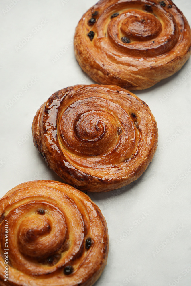 Baked pain aux raisins. Puff pastry bun with raisin Baked pain aux raisins. Puff pastry bun with raisin