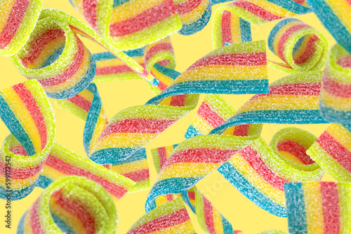 Levitation of colored jelly candy strips in sugar sprinkles.