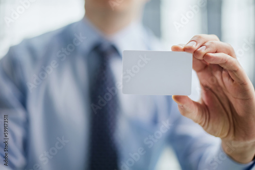 Businessman ,Business Man's hand hold showing business card - close up shot.