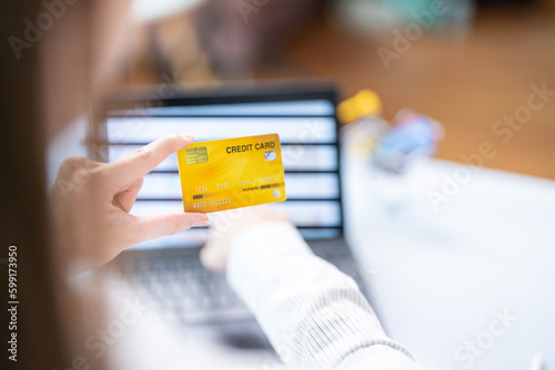 Fototapeta Naklejka Na Ścianę i Meble -  Concept of Online shopping, e-commerce, Woman holding credit card and using laptop computer for shopping online,Businesswoman paying for goods or services using credit card through online channels