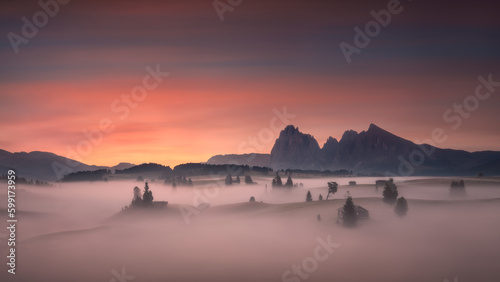 Dolomites mountain valley at beautifull misty foggy dawn