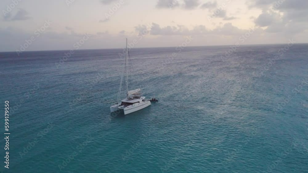 Aerial Drone View of Bahamas secluded island with solitary sailboat and dingy Aerial Drone View of Bahamas secluded island with solitary sailboat and dingy
