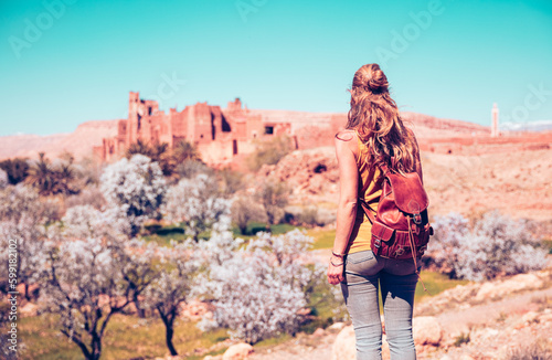 Woman tourist looking at fortified city, Telouet Kasbah in Morocco in spring