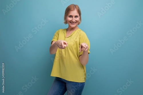 energetic mature woman pointing finger at camera