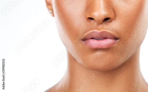 It takes a lot to impress her. Studio closeup of an unrecognizable woman standing against a white background during the day.
