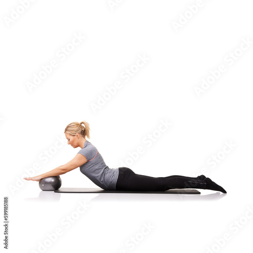 Arching her back and forcing it down. A young woman using an exercise ball while lying down - isolated.