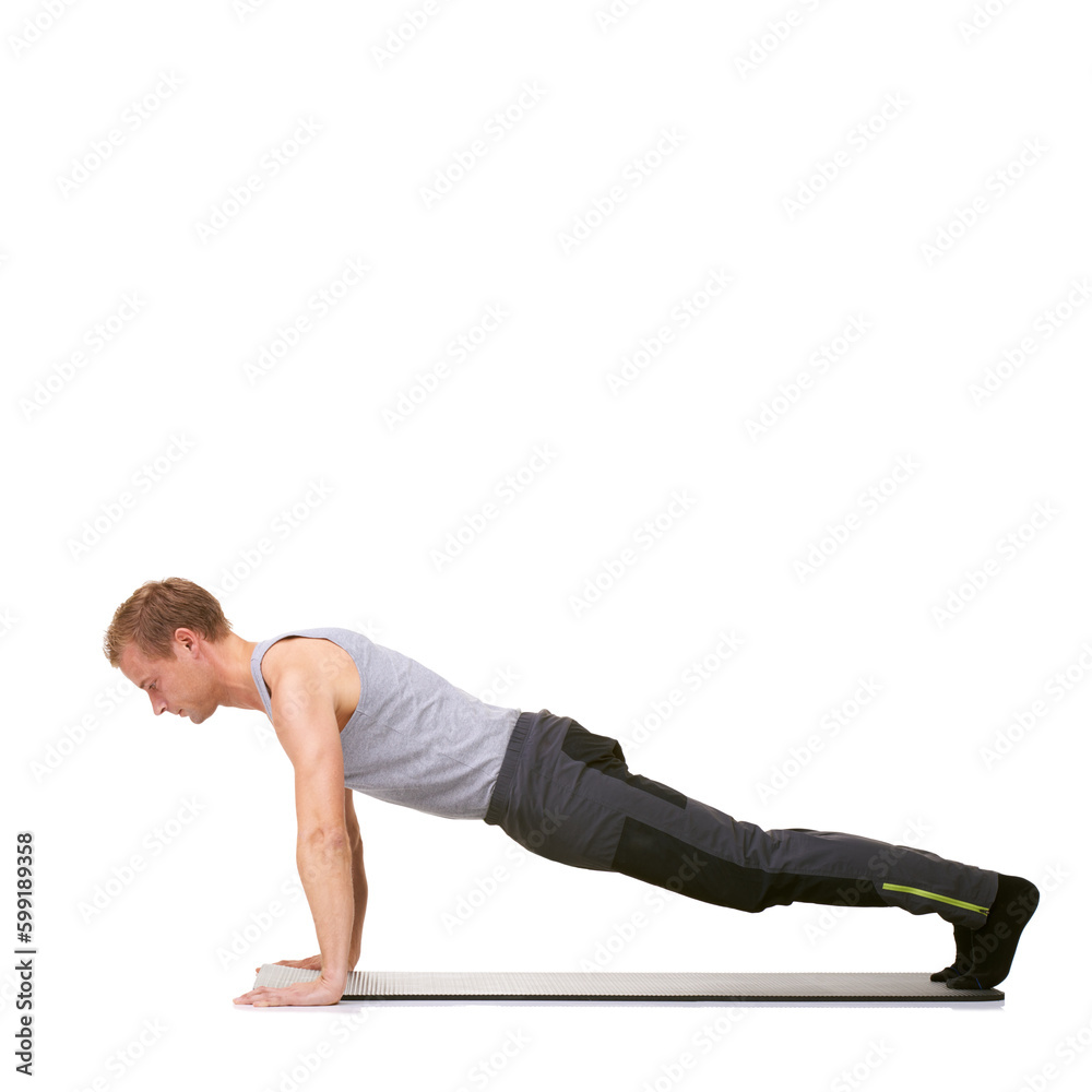 Perfect technique brings results. A fit young man doing push-ups on his exercise mat while isolated on white.