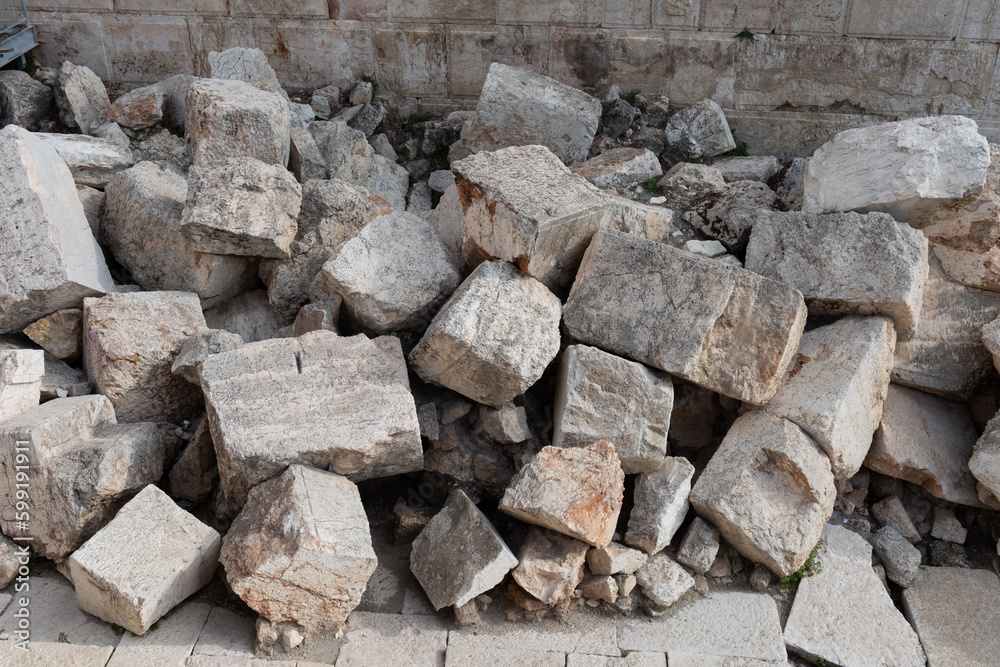 Fototapeta premium Large pile of giant stones at the base of the Western Wall in Jerusalem, beneath Robinson's Arch, believed to be ruins of the Second Jewish Temple, destroyed by the Romans in 70 AD. 