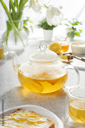 tea with lemon in a glass teapot