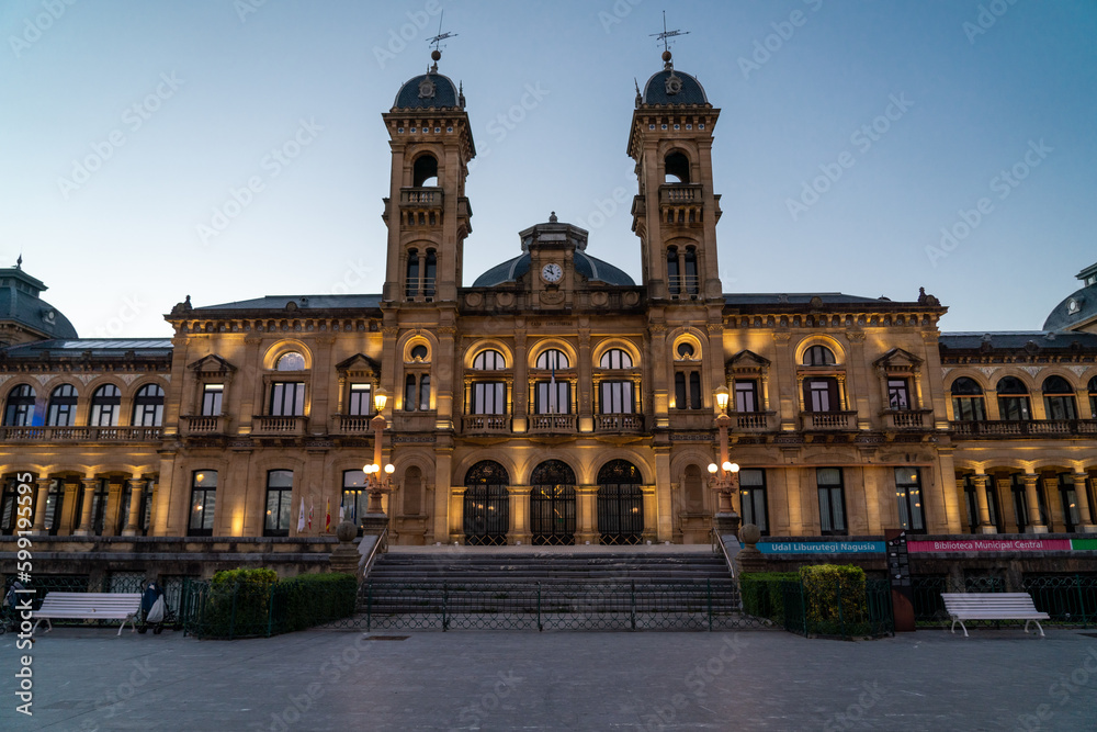San Sebastian, SPAIN - July 09 2022 Streets of San Sebastian - Donostia. View of Town Hall building at night luminated. Famous travel destination in north of Spain. 