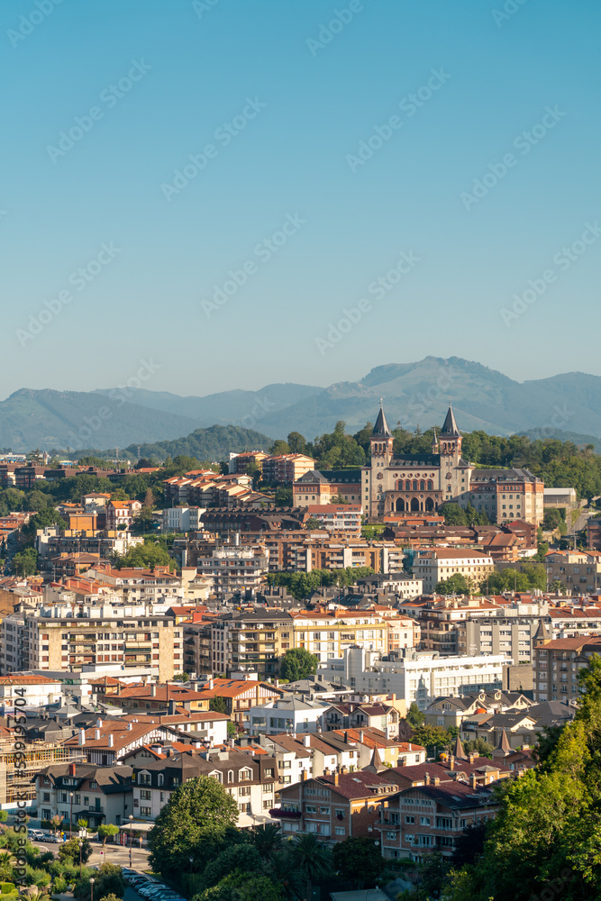Obraz premium San Sebastian, SPAIN - July 09 2022: High angle view of San Sebastian - Donostia City. Travel destination in north of Spain in Vesque Country. View of city center. In background hills and mountains. 