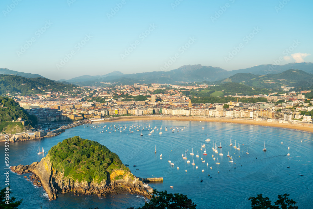 San Sebastian, SPAIN - July 09 2022: High angle view of San Sebastian - Donostia city at sunset. Situated in north of Spain, Basque Country. Famous travel destination. View of La Concha Bay