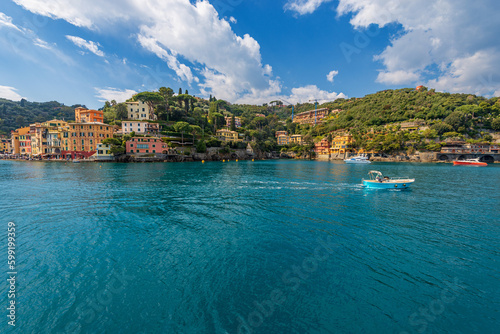 Port and bay of the famous village of Portofino, luxury tourist resort in Genoa Province, Liguria, Italy, Europe. Colorful houses, Mediterranean sea (Ligurian sea).