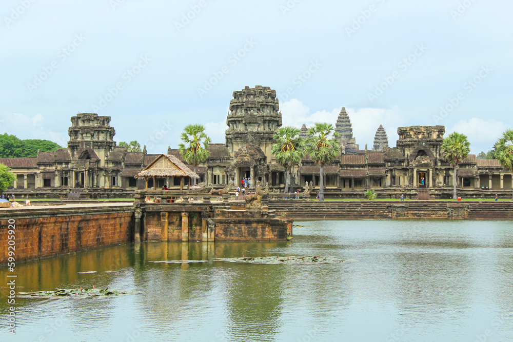 Naklejka premium Angkor Wat temple reflecting in water of Lotus pond at sunset. Siem Reap. Cambodia. Panorama