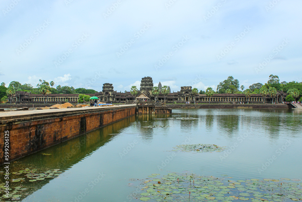 SIEM REAP, CAMBODIA. August 7th, 2019: Stone Bridge At Large Towers At Angkor Wat Temple Complex. Angkor Wat Is A Temple Complex In Cambodia And Is The Largest Religious Monument In The World.