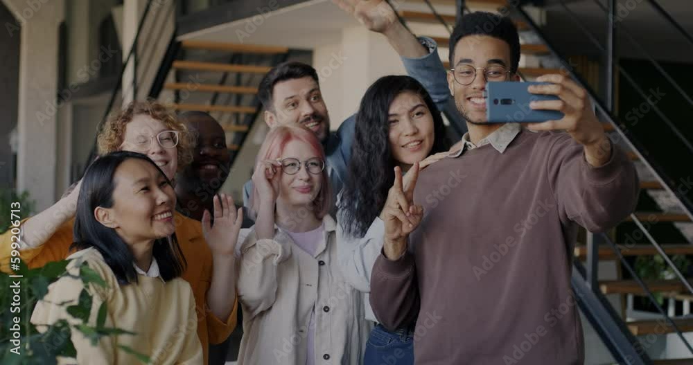 Group of businesspeople taking selfie in office using smartphone posing having fun at work. Photography and company employees concept. Group of businesspeople taking selfie in office using smartphone posing having fun at work. Photography and company employees concept.