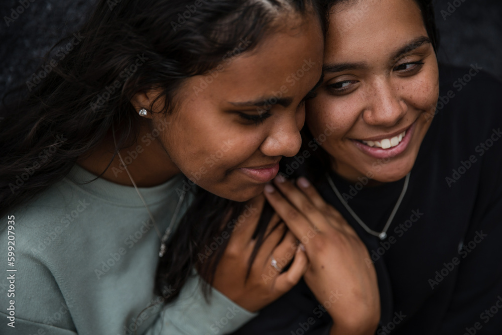 Close-up of two Aboriginal girls hugging Close-up of two Aboriginal girls hugging