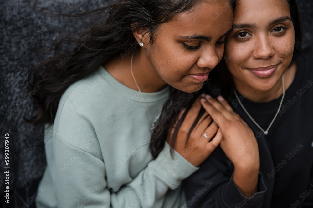Close-up of two Aboriginal girls hugging Close-up of two Aboriginal girls hugging