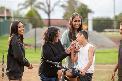 Aboriginal family laguhing and talking outside