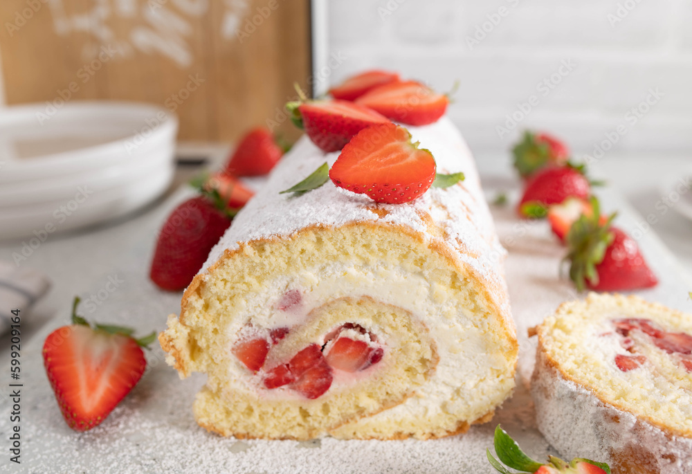Cake roll with strawberries and whipped cream